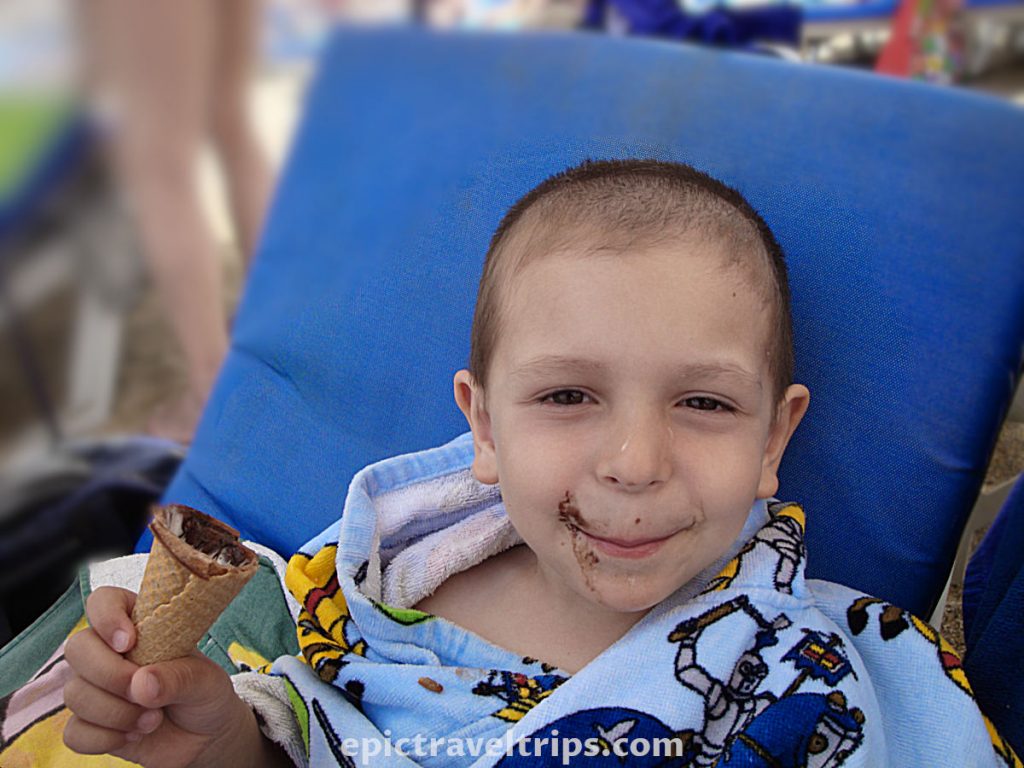 Boy eat ice cream on the Kleopatra beach in Alanya Turkey