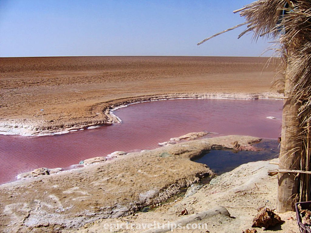 Chott el Djerid. Small pool of red water in the dry saline lake. Part of our Adventurous Three Days Epic Sahara Tour In Amazing Tunisia With Hidden Gems.