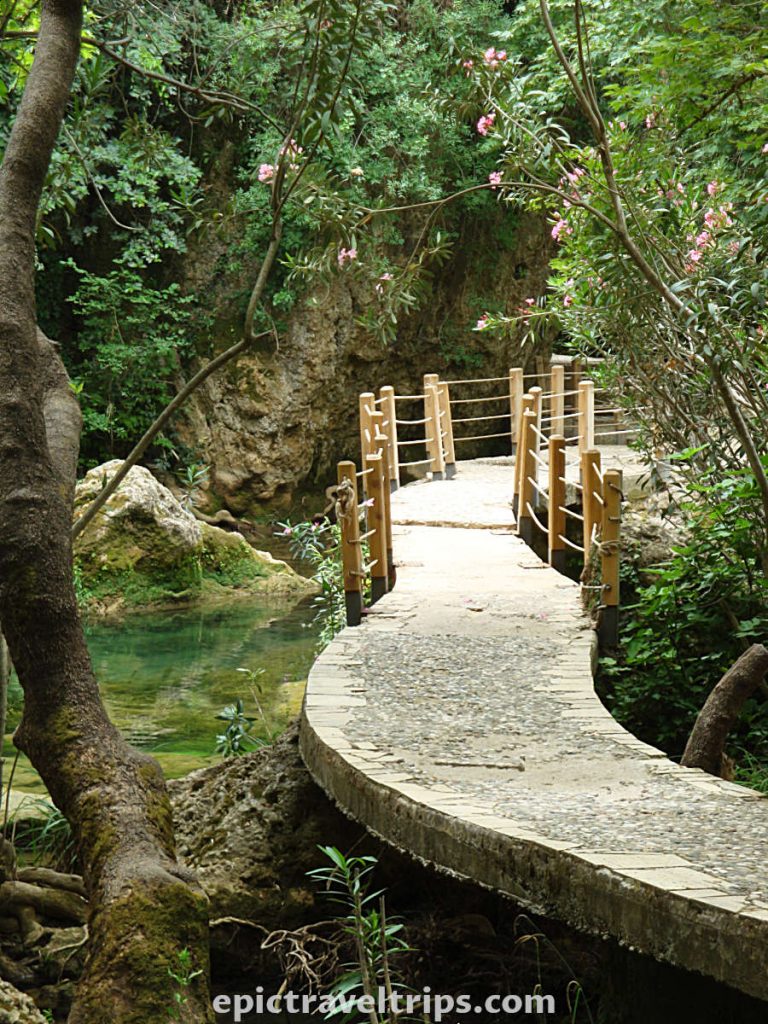Kursunlu Waterfalls in Turkey with concrete pathway and wooden poles