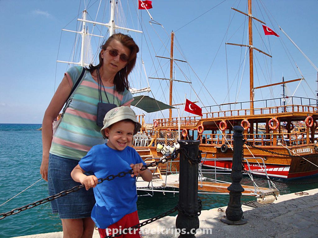 Women and boy in front of Turkish gulets at Side port