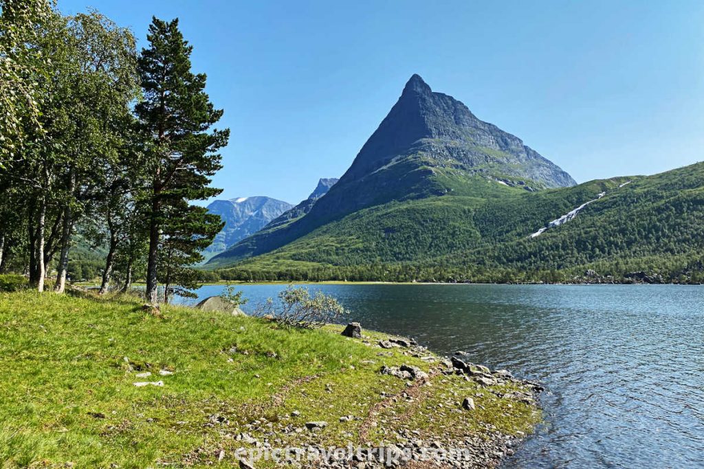 Innerdalen valley, lake, and mountains on a sunny day.