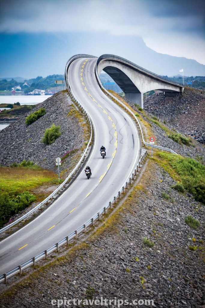Two bikers on the Storseisund bridge at Altantic Ocean Road in Norway.
