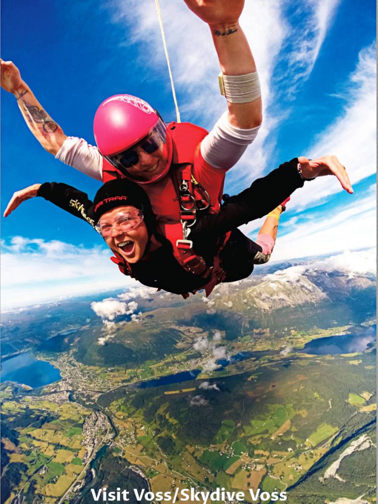 Two persons skydive over Voss town in Norway.
