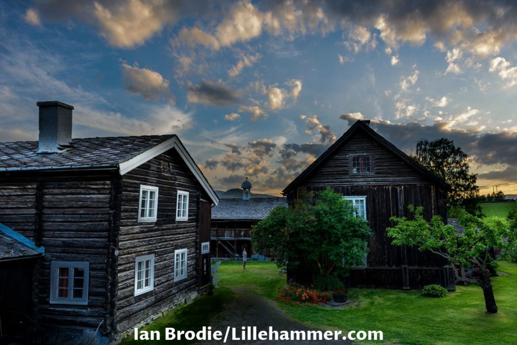 Sygard Grytting black farmhouses with green grass yard at Gudbrandsdalen valley in Norway.