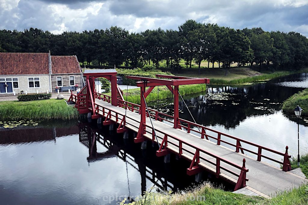 Red bridge over the moat at Fort Bourtange in The Netherlands.