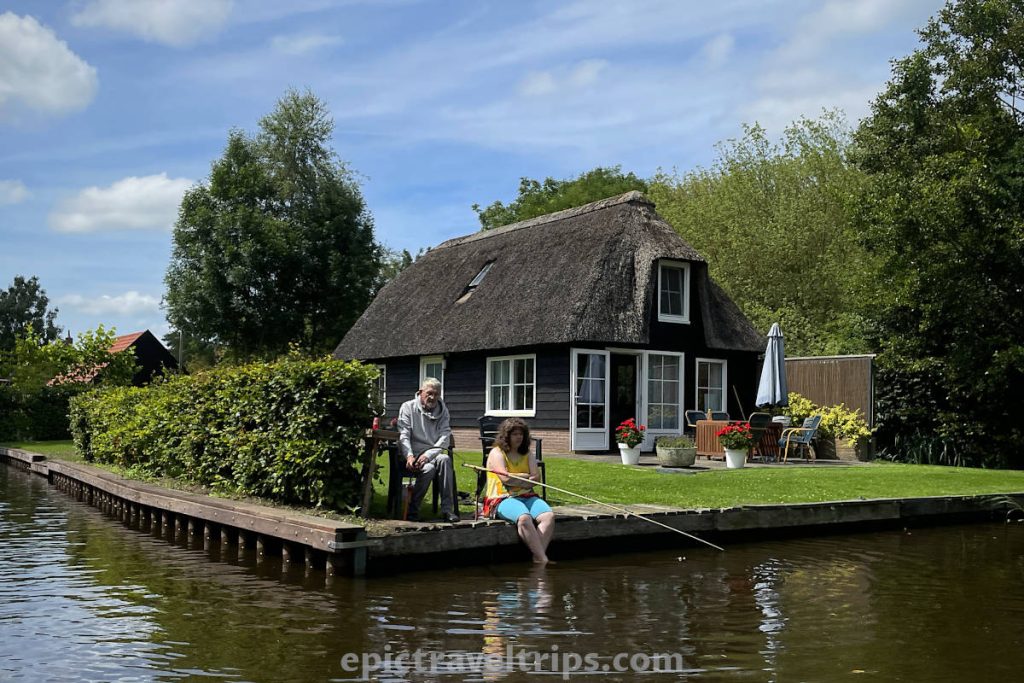 Two people fishing on the canal at Giethoorn Village in The Netherlands