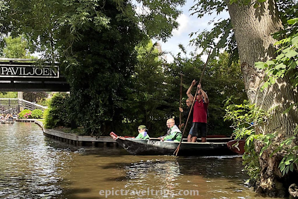 A man push pole against the canal bad in the punt boat at Giethoorn Village in The Netherlands