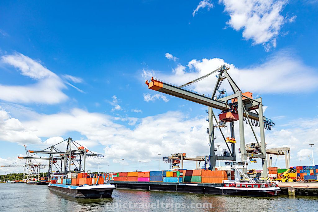 Unloading containers from a ship with crane in Rotterdam port in The Netherlands.